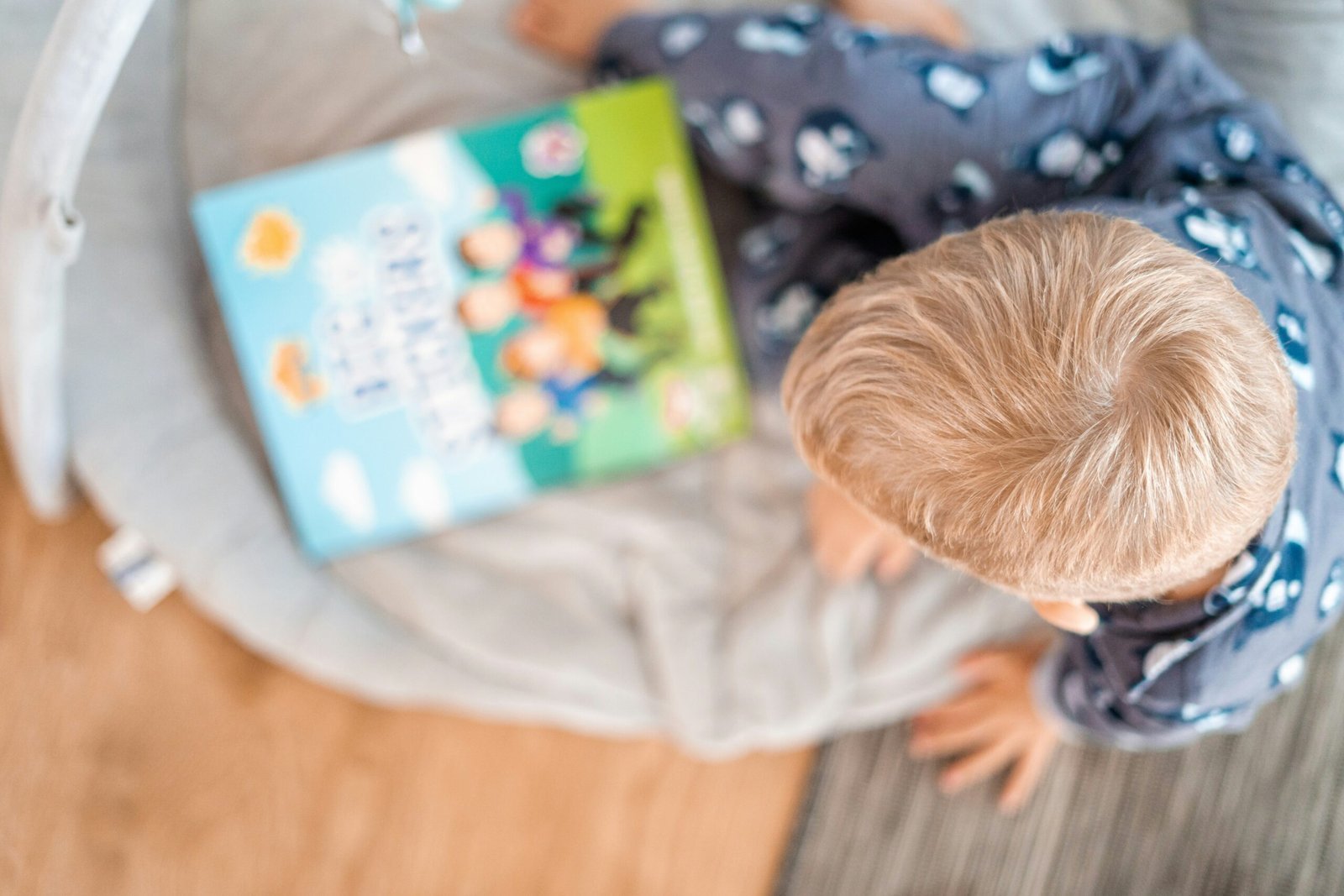 child reading a book on the floor